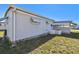 Well-maintained exterior features vinyl siding, trimmed windows, and an efficient air conditioning unit at 13225 101St St # 107, Largo, FL 33773