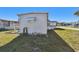 Cozy home exterior featuring a compact utility area and neat landscaping at 13225 101St St # 107, Largo, FL 33773