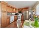 Open kitchen area showcases white appliances, wood cabinetry, and tile backsplash at 13225 101St St # 107, Largo, FL 33773