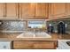 Kitchen area featuring wood cabinetry and countertops, complete with tile backsplash at 13225 101St St # 107, Largo, FL 33773