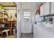 Laundry room with a washer, dryer, utility sink, and storage shelves at 13225 101St St # 107, Largo, FL 33773