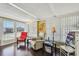 This room features hard wood floors, white recliner chair and lots of light at 13225 101St St # 107, Largo, FL 33773