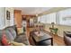 This cozy living room showcases a smooth flow to the kitchen with wood floors and light-filled windows at 13225 101St St # 107, Largo, FL 33773