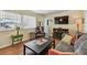 Cozy living room features hardwood floors, plush seating, and fireplace for a relaxing atmosphere at 13225 101St St # 107, Largo, FL 33773