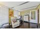 This living space includes hard wood floors, a comfy chair, a dresser, and an exit door at 13225 101St St # 107, Largo, FL 33773