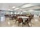 A large community meeting room is filled with tables and chairs, ready for gatherings and events at 13225 101St St # 107, Largo, FL 33773