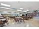 Spacious meeting room featuring tables, chairs, ample lighting, and decorative wall art for community activities at 13225 101St St # 107, Largo, FL 33773