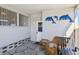 Exterior view of an enclosed patio with seating and decorative dolphin art at 13225 101St St # 107, Largo, FL 33773
