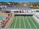 Aerial view of active shuffleboard courts next to a pool area with lounge chairs at 13225 101St St # 107, Largo, FL 33773