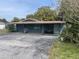 Charming single-story home with a covered parking area, offering a blend of comfort and convenience at 14612 Coral Dr, Hudson, FL 34667