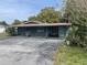 Single-story home with covered parking, landscaped yard, blending suburban comfort and outdoor charm at 14612 Coral Dr, Hudson, FL 34667