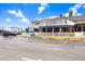 Exterior of a waterfront restaurant featuring outdoor dining and ample parking, perfect for seaside dining at 14612 Coral Dr, Hudson, FL 34667