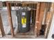 This modern water heater is framed by exposed wooden studs and essential plumbing for home comfort and efficiency at 14612 Coral Dr, Hudson, FL 34667