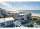 Beautiful aerial view of a beachside condo complex with a pool and stunning ocean views at 15 Glendale St # B6, Clearwater Beach, FL 33767