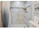 Tiled shower and toilet area of bathroom with neutral color scheme at 15 Glendale St # B6, Clearwater Beach, FL 33767