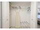Well-organized closet featuring shelving and an ironing board at 15 Glendale St # B6, Clearwater Beach, FL 33767