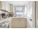 Well-lit kitchen featuring a stainless steel dishwasher and a window with a view at 15 Glendale St # B6, Clearwater Beach, FL 33767