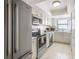 Bright kitchen featuring stainless steel appliances, tile backsplash, and light cabinetry at 15 Glendale St # B6, Clearwater Beach, FL 33767