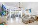 Comfortable living room with tile floors, balcony access and a neutral color palette at 15 Glendale St # B6, Clearwater Beach, FL 33767