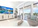Bright living room features tile floors, modern furnishings, balcony access and comfortable seating area at 15 Glendale St # B6, Clearwater Beach, FL 33767