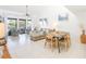 Bright living room featuring balcony access, tile flooring, and comfortable seating with stylish decor at 15 Glendale St # B6, Clearwater Beach, FL 33767