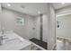 Modern bathroom with a walk-in shower, dual sink vanity, and stylish tile accents at 15409 Coot Rd, Weeki Wachee, FL 34614