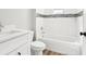 Bright bathroom featuring stylish vanity and tiled shower-tub combo with modern fixtures at 15409 Coot Rd, Weeki Wachee, FL 34614