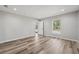 Empty bedroom with a window view, neutral paint, and stylish wood-look flooring at 15409 Coot Rd, Weeki Wachee, FL 34614