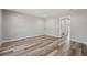 Empty bedroom with light gray walls, recessed lighting, and wood flooring at 15409 Coot Rd, Weeki Wachee, FL 34614