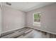 Bedroom featuring durable floors and a window offering a pleasant view of the outdoors at 15409 Coot Rd, Weeki Wachee, FL 34614