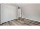 Bedroom featuring a closet with white folding doors, neutral paint, and wood-look flooring at 15409 Coot Rd, Weeki Wachee, FL 34614