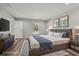 Cozy bedroom with a large bed, soft rug, and art, illuminated by recessed lighting and a window at 15409 Coot Rd, Weeki Wachee, FL 34614