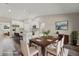 Open dining room and kitchen with an island, white cabinetry, stainless steel appliances, and wood floors at 15409 Coot Rd, Weeki Wachee, FL 34614