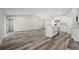 Open layout showcasing wood floors and white cabinetry, connecting the kitchen and living area at 15409 Coot Rd, Weeki Wachee, FL 34614