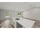 Kitchen island with stainless steel appliances, opening into the living space with sliding glass doors at 15409 Coot Rd, Weeki Wachee, FL 34614