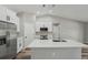Bright kitchen featuring white cabinets, stainless steel appliances, and a spacious center island at 15409 Coot Rd, Weeki Wachee, FL 34614