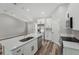 Modern kitchen featuring a large island with white countertops, stainless steel appliances, and ample storage at 15409 Coot Rd, Weeki Wachee, FL 34614