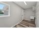 Bright laundry room includes a sink and hanging rack, complemented by a view from the window at 15409 Coot Rd, Weeki Wachee, FL 34614