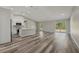 Spacious living room featuring wood flooring, a kitchen island, recessed lighting, and a sliding glass door at 15409 Coot Rd, Weeki Wachee, FL 34614