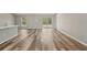 Spacious living room featuring light gray walls, wood flooring, and a sliding glass door at 15409 Coot Rd, Weeki Wachee, FL 34614