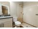 Bathroom featuring a tiled shower, dark countertop, and white vanity at 15838 49Th N St, Clearwater, FL 33762