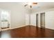 Bedroom with ceiling fan, neutral paint, wood-look floor, and closet space at 15838 49Th N St, Clearwater, FL 33762