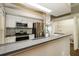 Modern kitchen with stainless steel appliances, granite countertops, and white cabinetry at 15838 49Th N St, Clearwater, FL 33762