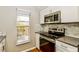 Bright kitchen featuring stainless steel appliances, and granite countertops at 15838 49Th N St, Clearwater, FL 33762