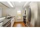 Modern kitchen with stainless steel appliances, granite countertops, and tile backsplash at 15838 49Th N St, Clearwater, FL 33762