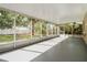 Large screened porch with a view of the backyard and mature landscaping at 15838 49Th N St, Clearwater, FL 33762