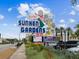 A colorful 'Sunken Gardens' sign is displayed next to a street with lush vegetation and nearby attractions at 1666 N Dakota Ne Ave, St Petersburg, FL 33703