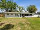 Spacious backyard featuring a well-maintained lawn and a view of the home's exterior, including the screened-in patio at 1666 N Dakota Ne Ave, St Petersburg, FL 33703