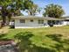 Expansive backyard with lush lawn, perfect for outdoor activities and gatherings, with a view of the screened-in patio at 1666 N Dakota Ne Ave, St Petersburg, FL 33703