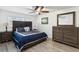 This is a cozy bedroom featuring wood laminate flooring, a ceiling fan, and attractive furnishings at 1666 N Dakota Ne Ave, St Petersburg, FL 33703